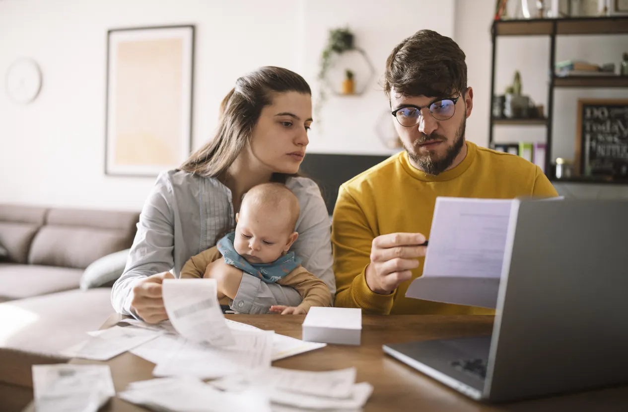 Family looking at bills with baby